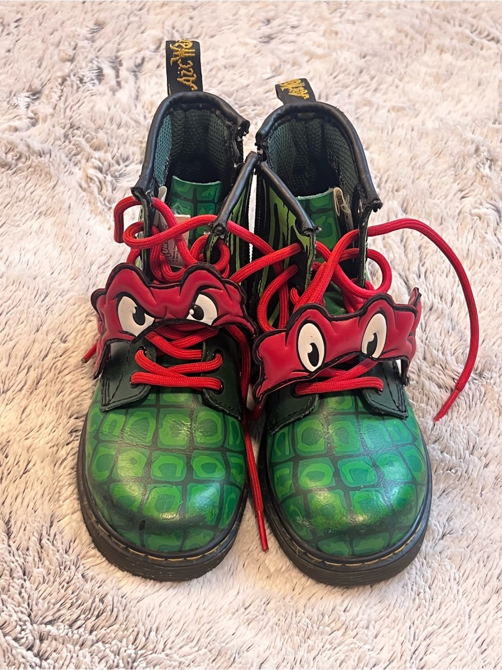 Dr. Martens Kids Green Croc-Pattern Boots with Red Eye Accent